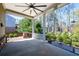 Inviting covered patio featuring a ceiling fan and views of the landscaped backyard at 2434 Soft Maple St, Atlanta, GA 30360