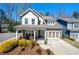 Charming two-story home with a welcoming front porch and a well-manicured landscaped yard at 2434 Soft Maple St, Atlanta, GA 30360