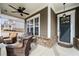 Inviting front porch showcasing wicker seating, a ceiling fan, and a stylish black front door at 2434 Soft Maple St, Atlanta, GA 30360