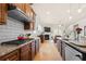 Open kitchen with stainless appliances, an island with bar stools, granite counters, and seamless flow to the living room at 2434 Soft Maple St, Atlanta, GA 30360
