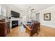 Cozy living room featuring hardwood floors, fireplace, comfortable seating and a ceiling fan at 2434 Soft Maple St, Atlanta, GA 30360