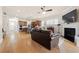 Open concept living room with hardwood floors, fireplace and adjacent kitchen with an island at 2434 Soft Maple St, Atlanta, GA 30360