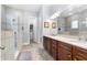 Main bathroom featuring dual sinks, a walk-in shower with tiling and a view into the walk-in closet at 2434 Soft Maple St, Atlanta, GA 30360