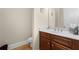 Elegant powder room with a wood vanity, white countertop, and framed wall art at 2434 Soft Maple St, Atlanta, GA 30360