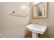 Cozy half bath featuring a white pedestal sink and a framed mirror at 5392 Fox Creek Ln, Norcross, GA 30071