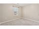 Neutral bedroom featuring a window with blinds and plush carpeting at 5392 Fox Creek Ln, Norcross, GA 30071
