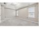 Bedroom with a tray ceiling, neutral paint, and dual windows at 5392 Fox Creek Ln, Norcross, GA 30071