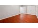 Spacious bedroom featuring beautiful hardwood floors, two closets, and neutral walls at 5392 Fox Creek Ln, Norcross, GA 30071