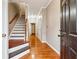 Inviting entryway with gleaming hardwood floors, staircase, and elegant white trim throughout at 5392 Fox Creek Ln, Norcross, GA 30071