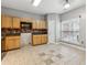 Spacious kitchen featuring wooden cabinets, stainless steel appliances, and tile flooring at 5392 Fox Creek Ln, Norcross, GA 30071