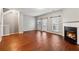 Spacious living room featuring hardwood floors, a fireplace, and sliding glass doors at 5392 Fox Creek Ln, Norcross, GA 30071