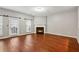 Open-concept living room featuring hardwood floors, a fireplace, and sliding glass doors leading to the outdoors at 5392 Fox Creek Ln, Norcross, GA 30071