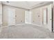 Large main bedroom with neutral carpet and ensuite bathroom at 5392 Fox Creek Ln, Norcross, GA 30071