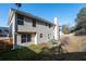 View of the backyard including a wood fence, patio area, and lush greenery at 1893 Tulip Petal Rd, Auburn, GA 30011
