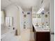 Clean bathroom featuring a soaking tub and dual sink vanity at 1893 Tulip Petal Rd, Auburn, GA 30011
