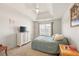 Cozy bedroom features a neutral palette, a single bed and a bright window at 1893 Tulip Petal Rd, Auburn, GA 30011