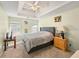 Spacious bedroom featuring a trey ceiling, plush carpet, and two windows for ample natural light at 1893 Tulip Petal Rd, Auburn, GA 30011