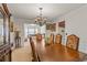 Refined dining room with an elegant chandelier, a large wooden table, and ample seating for formal gatherings at 1893 Tulip Petal Rd, Auburn, GA 30011