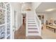 Inviting foyer with a grand staircase, tile flooring, and abundant natural light, creating a warm entrance at 1893 Tulip Petal Rd, Auburn, GA 30011