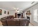 Cozy living room showcasing a beautiful fireplace, comfortable seating, and a ceiling fan at 1893 Tulip Petal Rd, Auburn, GA 30011