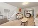 Sunlit living room boasting classic furniture, an open layout and easy access to the dining area at 1893 Tulip Petal Rd, Auburn, GA 30011