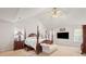 Bright primary bedroom with a vaulted ceiling, a four-poster bed, and soft carpeting at 1893 Tulip Petal Rd, Auburn, GA 30011