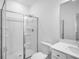 Bright bathroom featuring a glass shower, white tile, and modern vanity with ample counter space at 6055 Misty Hill Ln, Buford, GA 30518