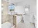 Modern bathroom showcasing a tiled shower, soaking tub, and neutral color palette at 6055 Misty Hill Ln, Buford, GA 30518