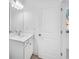 Bathroom vanity with a single sink and modern lighting at 6055 Misty Hill Ln, Buford, GA 30518