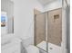 Bathroom showcasing tiled shower with glass door and neutral color scheme at 6055 Misty Hill Ln, Buford, GA 30518