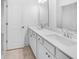 Bright bathroom featuring a double vanity with modern fixtures at 6055 Misty Hill Ln, Buford, GA 30518