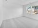 A bright bedroom featuring carpet and three large windows at 6055 Misty Hill Ln, Buford, GA 30518