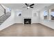 Bright living room featuring wood floors, a cozy fireplace and many windows providing natural light at 6055 Misty Hill Ln, Buford, GA 30518