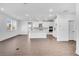 Spacious living area flows into the kitchen, showcasing wood floors, white cabinets and a center island at 6055 Misty Hill Ln, Buford, GA 30518