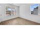 Bright living room featuring wood floors, white walls and trim, and large windows with neighborhood views at 6055 Misty Hill Ln, Buford, GA 30518