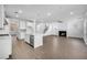 Open floor plan with a modern kitchen, dining area and a living room with a fireplace and wood floors at 6055 Misty Hill Ln, Buford, GA 30518