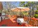 Back deck featuring a round table and chairs with an umbrella overlooking the natural landscape at 13 Greystone Nw Ln, Cartersville, GA 30121