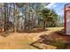 Large backyard featuring mature trees and a swing set at 13 Greystone Nw Ln, Cartersville, GA 30121