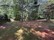 Lawn backyard with lush trees offers ample space for outdoor activities at 13 Greystone Nw Ln, Cartersville, GA 30121
