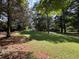 Tree-lined backyard with lush grass offers space for outdoor activities at 13 Greystone Nw Ln, Cartersville, GA 30121