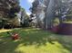 Lush backyard with green grass, mature trees, and play equipment at 13 Greystone Nw Ln, Cartersville, GA 30121