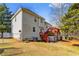 A wide shot of the backyard featuring a deck, stairs, shed, and mature trees at 13 Greystone Nw Ln, Cartersville, GA 30121