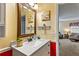 Bright bathroom featuring a framed mirror, vanity with solid surface countertop, and decorative wall art at 13 Greystone Nw Ln, Cartersville, GA 30121