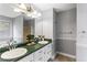 Bathroom featuring double sinks, green marble countertop, and gray walls at 13 Greystone Nw Ln, Cartersville, GA 30121