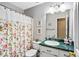 Cozy bathroom with a floral shower curtain, vanity with decorative accessories, and great lighting at 13 Greystone Nw Ln, Cartersville, GA 30121