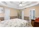 Comfortable bedroom features neutral walls, tray ceiling, and multiple doors to other rooms at 13 Greystone Nw Ln, Cartersville, GA 30121