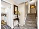 Hallway featuring kitchen access, stairs to upper level, accent lighting, and laminate hardwood flooring at 13 Greystone Nw Ln, Cartersville, GA 30121