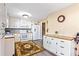 Well-lit kitchen with appliances, ample counter space, stylish cabinets, and hardwood laminate flooring at 13 Greystone Nw Ln, Cartersville, GA 30121