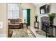 Comfortable living room featuring a stone fireplace, large window, plush sofa, and stylish decor at 13 Greystone Nw Ln, Cartersville, GA 30121