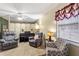 Living room featuring comfortable seating, a piano, neutral walls, and window at 13 Greystone Nw Ln, Cartersville, GA 30121
